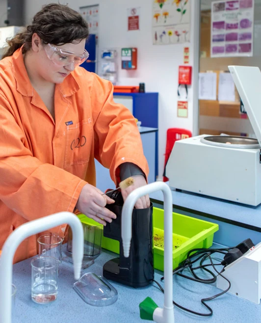 Student using lab equipment with centrifuge in science lab during practical session Student using lab equipment with centrifuge in science lab during practical session